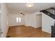 Bright living room with hardwood floors, ceiling fan, and view of staircase at 309 N Lasalle St, Indianapolis, IN 46201