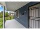 Covered porch with a metal security door and gray flooring at 309 N Lasalle St, Indianapolis, IN 46201