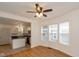 Living room with hardwood floors, kitchen island view, and a ceiling fan at 309 N Lasalle St, Indianapolis, IN 46201