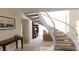 Elegant curved staircase with a white railing, opening to living room at 10781 Cedar Ridge Ln, Brownsburg, IN 46278