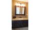 Bathroom with granite countertop, dark wood cabinets, and a framed mirror at 10781 Cedar Ridge Ln, Brownsburg, IN 46278