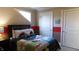 bedroom with vehicle-themed bedding and red accent wall at 10781 Cedar Ridge Ln, Brownsburg, IN 46278