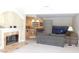 Open living space with a fireplace, kitchen bar, and comfortable seating at 10781 Cedar Ridge Ln, Brownsburg, IN 46278