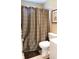 Brown and beige wave patterned shower curtain and toilet at 10781 Cedar Ridge Ln, Brownsburg, IN 46278