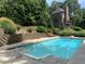 Inviting in-ground pool with stone patio and lush landscaping at 10781 Cedar Ridge Ln, Brownsburg, IN 46278