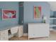 Blue bedroom with desk, dresser, and dinosaur artwork at 10781 Cedar Ridge Ln, Brownsburg, IN 46278