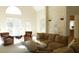 Sunlit living room with a comfortable seating arrangement and fireplace at 10781 Cedar Ridge Ln, Brownsburg, IN 46278