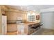 Well-equipped kitchen featuring light wood cabinets and a breakfast bar at 10781 Cedar Ridge Ln, Brownsburg, IN 46278