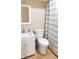 Clean bathroom featuring a toilet, sink, and shower with striped curtain at 10781 Cedar Ridge Ln, Brownsburg, IN 46278