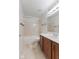 Clean bathroom with a tub, toilet and wood vanity at 9263 Golden Oaks W, Indianapolis, IN 46260