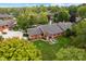 Aerial view of a brick home with a pond and lush landscaping at 9263 Golden Oaks W, Indianapolis, IN 46260
