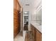 Bathroom with wood cabinets, a large mirror, and an adjacent bedroom at 9263 Golden Oaks W, Indianapolis, IN 46260