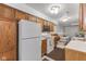 Open kitchen with white appliances and wood cabinets at 9263 Golden Oaks W, Indianapolis, IN 46260