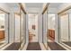 View of bathroom with mirrored closets and double sinks at 9263 Golden Oaks W, Indianapolis, IN 46260