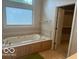 Relaxing bathroom with a jetted tub and walk-in closet at 4161 S Summit Ln, Columbus, IN 47201