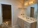 Double vanity bathroom with a large mirror and access to a walk-in closet at 4161 S Summit Ln, Columbus, IN 47201