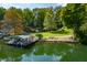 Aerial view of waterfront property with boat dock and lush landscaping at 3958 E Edgewood Cir, Martinsville, IN 46151