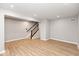 Spacious, unfinished basement with wood-look flooring and staircase at 7306 W County Road 600 Rd # 14-602, McCordsville, IN 46055