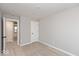 Empty bedroom featuring gray walls, plush carpeting, and access to an adjacent room at 7306 W County Road 600 Rd # 14-602, McCordsville, IN 46055