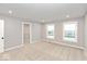 Empty bedroom with neutral gray walls, plush carpet, and two large windows at 7306 W County Road 600 Rd # 14-602, McCordsville, IN 46055