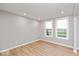 Bonus room with wood-look flooring and large windows providing natural light at 7306 W County Road 600 Rd # 14-602, McCordsville, IN 46055