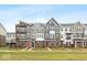 Row of modern townhouses with varied colors and architectural details at 7306 W County Road 600 Rd # 14-602, McCordsville, IN 46055