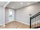 Inviting foyer space with wood-look flooring, front door, and staircase at 7306 W County Road 600 Rd # 14-602, McCordsville, IN 46055