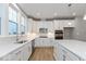 White kitchen with stainless steel appliances, ample counter space, and sleek cabinetry at 7306 W County Road 600 Rd # 14-602, McCordsville, IN 46055