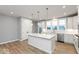 Bright, modern kitchen with white cabinets, a large island, and stainless steel appliances at 7306 W County Road 600 Rd # 14-602, McCordsville, IN 46055