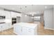 Open-concept kitchen and living area with a large island and modern finishes at 7306 W County Road 600 Rd # 14-602, McCordsville, IN 46055