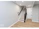 View of the staircase leading upstairs from the foyer with wood-look flooring at 7306 W County Road 600 Rd # 14-602, McCordsville, IN 46055