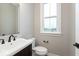 Powder room with dark wood vanity and window at 7310 W County Road 600 Rd # 14-603, McCordsville, IN 46055