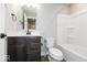 Modern bathroom with dark wood vanity, white tub/shower combo, and neutral decor at 7310 W County Road 600 Rd # 14-603, McCordsville, IN 46055