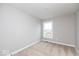 Empty bedroom with neutral-colored carpet and walls, and a single window at 7310 W County Road 600 Rd # 14-603, McCordsville, IN 46055