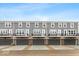 Townhouse complex with gray siding, attached garages, and private balconies at 7310 W County Road 600 Rd # 14-603, McCordsville, IN 46055