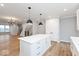 Open-concept kitchen and dining area with white cabinetry, island, and wood floors at 7310 W County Road 600 Rd # 14-603, McCordsville, IN 46055
