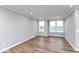 Bright living room with large windows and wood-look flooring at 7310 W County Road 600 Rd # 14-603, McCordsville, IN 46055