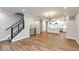 Open concept living and dining area with wood floors and modern chandelier at 7310 W County Road 600 Rd # 14-603, McCordsville, IN 46055