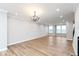 Spacious living area with chandelier, large windows, and wood-look flooring at 7310 W County Road 600 Rd # 14-603, McCordsville, IN 46055