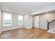 Spacious living room with wood-look flooring and access to stairs at 7310 W County Road 600 Rd # 14-603, McCordsville, IN 46055