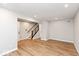 Open living room with wood-look flooring and a staircase at 7310 W County Road 600 Rd # 14-603, McCordsville, IN 46055