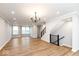 Open and airy living room with wood floors and a modern chandelier at 7310 W County Road 600 Rd # 14-603, McCordsville, IN 46055