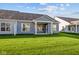 Home's exterior showcasing a backyard and patio at 10618 Maidenhair Dr, Indianapolis, IN 46239