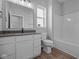 Clean bathroom with white vanity, grey countertop, and a bathtub at 10618 Maidenhair Dr, Indianapolis, IN 46239