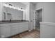 Bathroom with double vanity, large mirror, and walk-in closet at 10618 Maidenhair Dr, Indianapolis, IN 46239