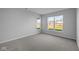 Bright bedroom with grey carpet and large windows at 10618 Maidenhair Dr, Indianapolis, IN 46239