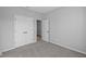 Simple bedroom with grey carpet, double door closet and an additional door at 10618 Maidenhair Dr, Indianapolis, IN 46239