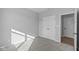 Bright bedroom with grey carpet and a double door closet at 10618 Maidenhair Dr, Indianapolis, IN 46239