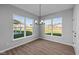 Sunlit dining area with hardwood floors and a view of the backyard at 10618 Maidenhair Dr, Indianapolis, IN 46239