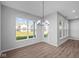 Spacious dining area with hardwood floors, large windows, and access to a patio at 10618 Maidenhair Dr, Indianapolis, IN 46239